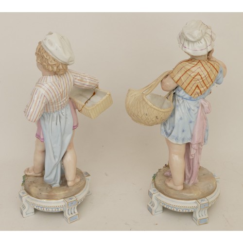 66 - A pair of 20th century porcelain figures, boy and girl each carrying a basket, raised on four suppor... 