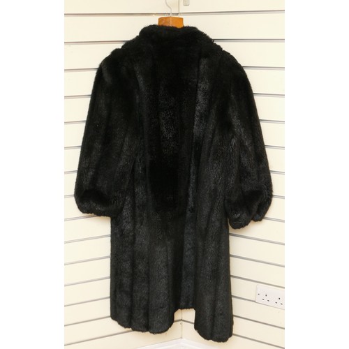 266 - A black faux fur coat, good condition.
size 12, approximately 115cm in length.