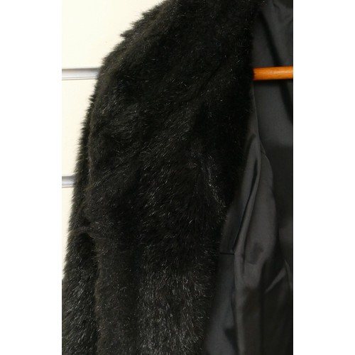 266 - A black faux fur coat, good condition.
size 12, approximately 115cm in length.