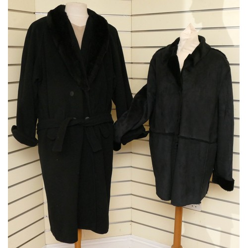 278 - A black long length button up wool coat with a faux fur collar, flap over concealed pockets, size 16... 