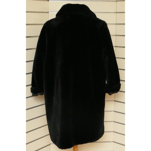 279 - A black 'Faux' fur mid length jacket, side concealed pockets, Size 12/L 98cm.