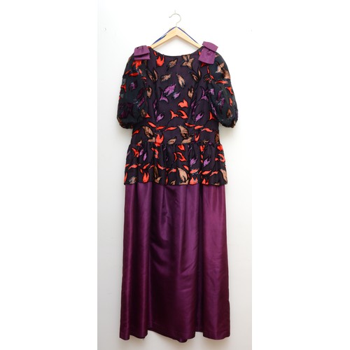 312 - A ladies ball gown with a full purple floor length skirt with a puff sleeved top in an abstract patt... 