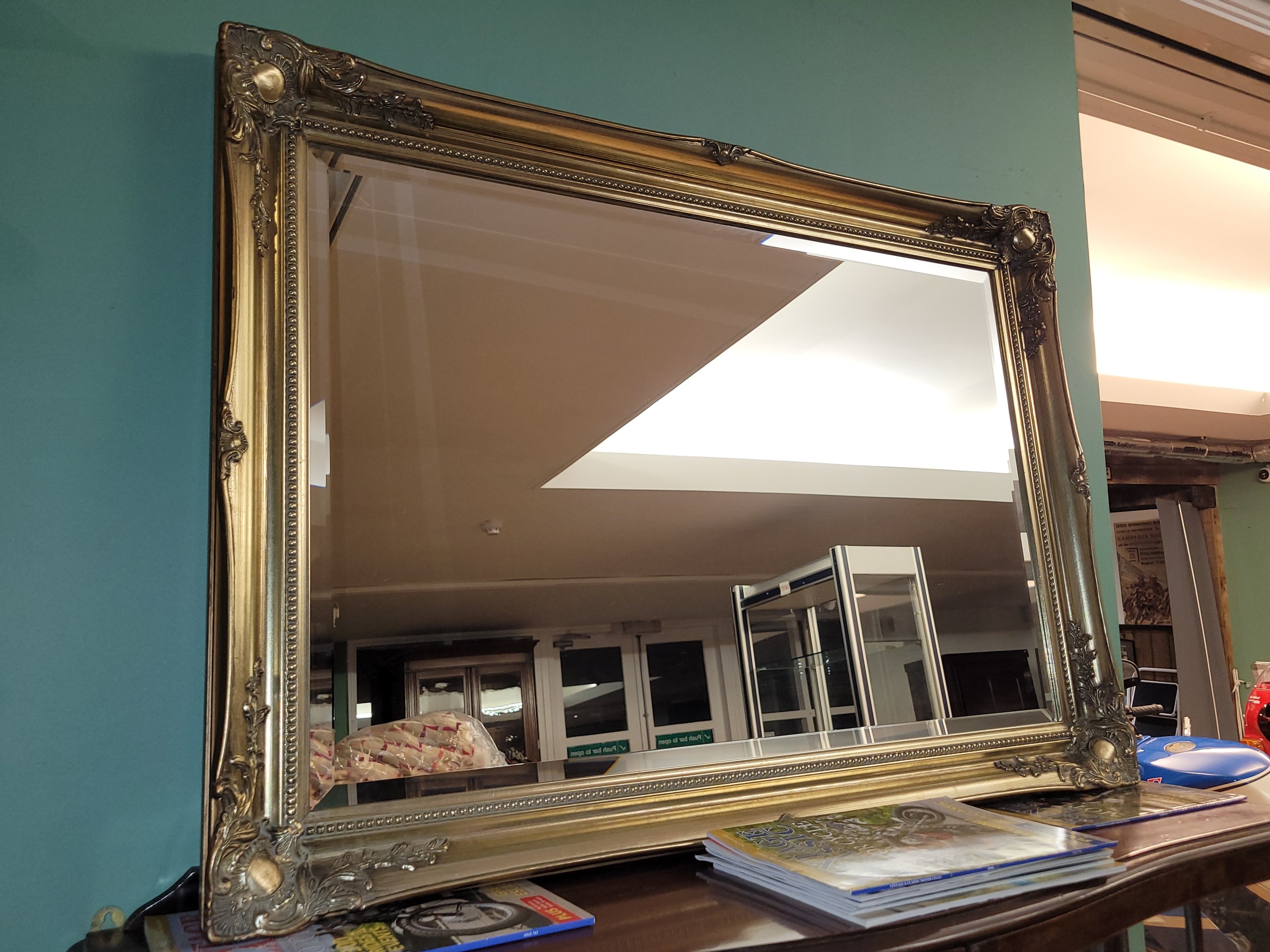 A contemporary gilt framed bevel edged rectangular wall mirror, 112x76cm