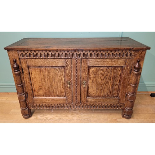 283 - A late 19th century oak low livery cupboard of Jacobean design, the framed panelled top over a acant... 