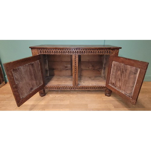 283 - A late 19th century oak low livery cupboard of Jacobean design, the framed panelled top over a acant... 