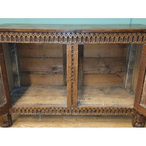 283 - A late 19th century oak low livery cupboard of Jacobean design, the framed panelled top over a acant... 