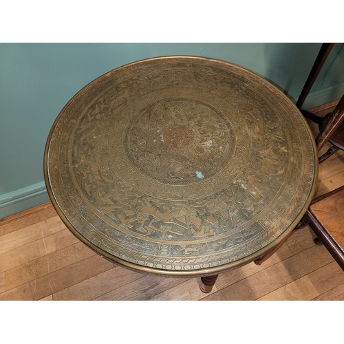 285 - A 20th century Indian Benares folding side table, having brass tray top incised with geometric and f... 