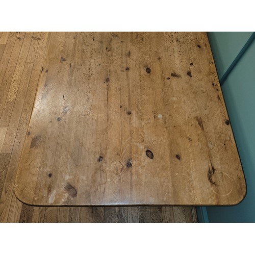 306 - A traditional waxed pine dining or kitchen table, rectangular top, raised on turned tapering support... 