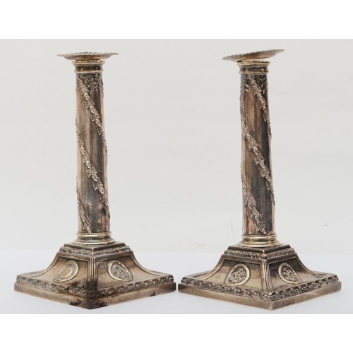 4 - A silver pair of candlesticks, by Barnard & Sons, London 1912, the tapering columns with spiral oak ... 