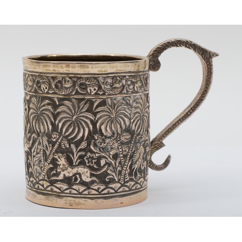 14 - An Indian silver small mug, embossed and chased with animals amongst palm trees, snake handle, 7.5cm... 