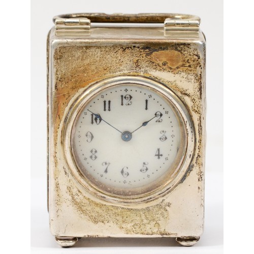 62 - A Victorian silver miniature clock, London 1898, in plain case, raised on four ball feet, C scroll h... 