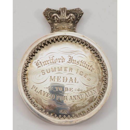 70 - A Victorian silver presentation medal, by J.C, c.1897, of circular form with Victorian crown surmoun... 