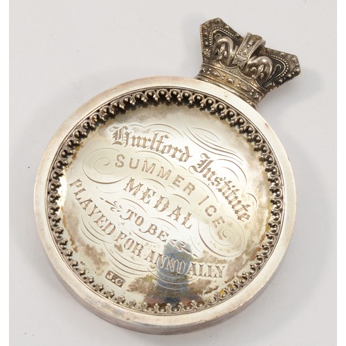 70 - A Victorian silver presentation medal, by J.C, c.1897, of circular form with Victorian crown surmoun... 