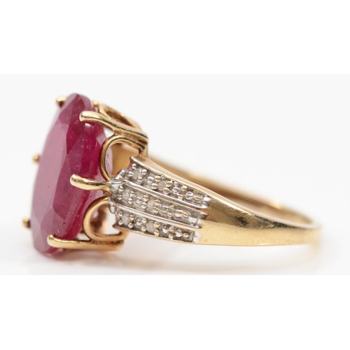 108 - A 9ct gold glass filled ruby cocktail dress ring, with eight cut diamond set shoulders, O, 3.9gm.