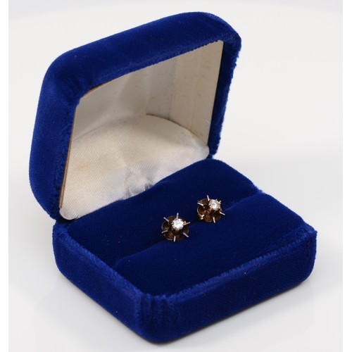 111 - A pair of unmarked gold brilliant cut diamond single stone floral stud earrings, stamped 9ct to butt... 