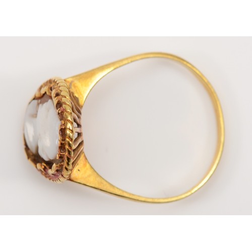 120 - A vintage 750 gold carved shell cameo dress ring, with rope twist decoration, O, 3gm.