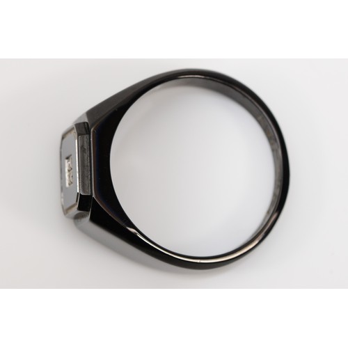 121 - Ken-Terry; a contemporary blackened stainless steel gentleman's ring, with onyx panel set with four ... 