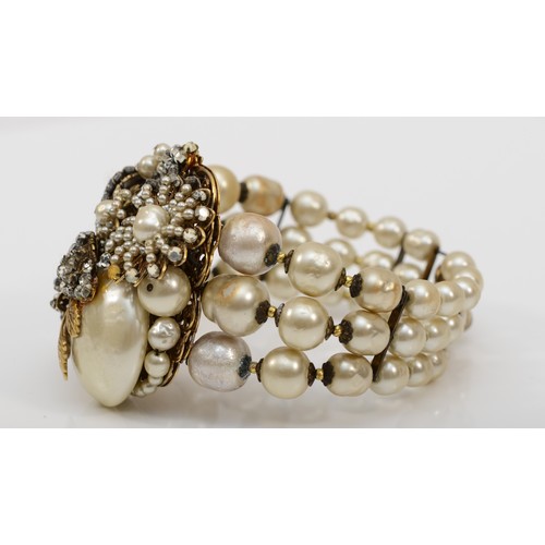 122 - A Miriam Haskell three strand faux baroque pearl and foil backed rhinestone floral bracelet, c.1950,... 