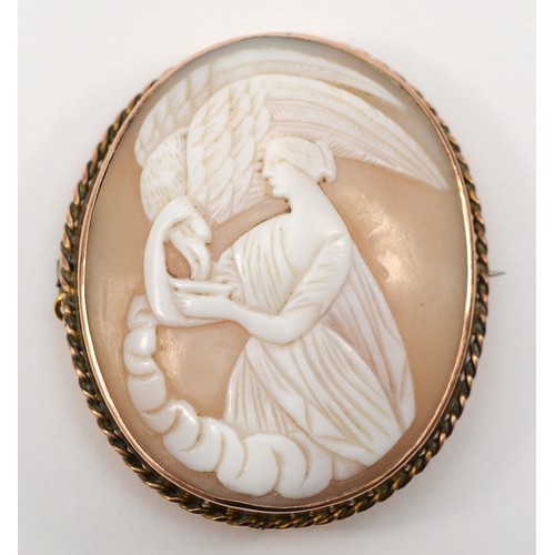 126 - A gold shell carved cameo brooch, c.1900, depicting Hebe goddess of youth feeding Zeus in the guise ... 