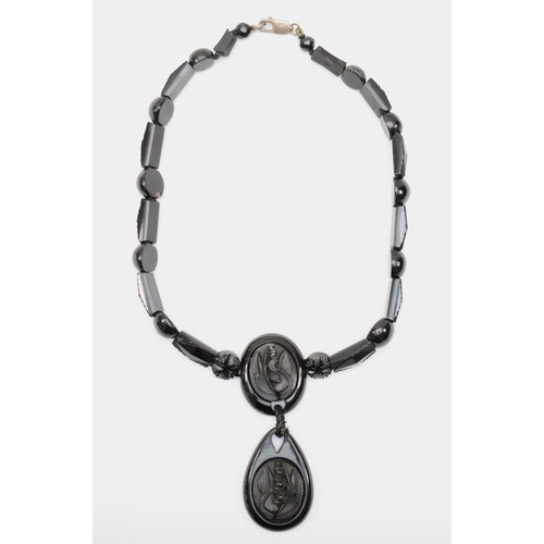 127 - A Victorian Whitby jet and silver clasped necklace, with carved floral pendant and spacers, 44cm, re... 