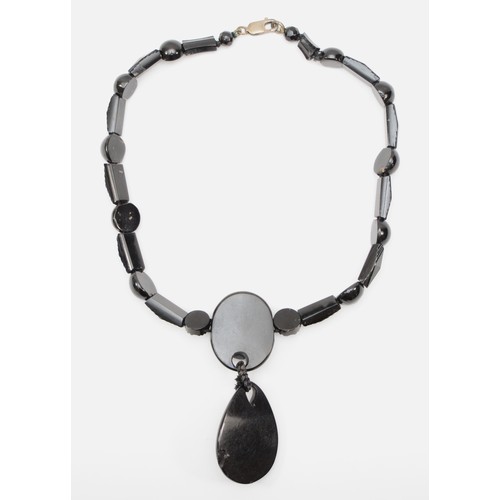 127 - A Victorian Whitby jet and silver clasped necklace, with carved floral pendant and spacers, 44cm, re... 