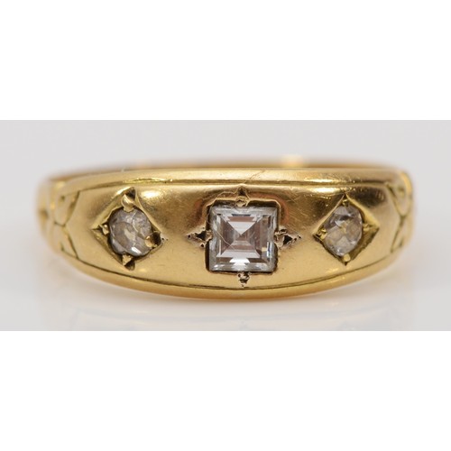 129 - A Victorian three stone diamond gypsy ring,   replacement square cut central diamond flanked by two ... 