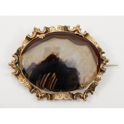 131 - A Victorian gold mounted agate brooch, with chased scroll border, unmarked, 58 x 42mm, 18gm, base me... 