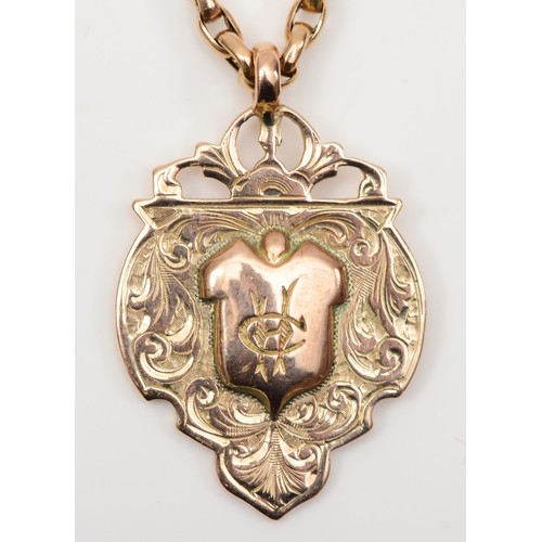 136 - A George V 9ct gold shield watch fob, by William Dingley, Birmingham 1910, with chased foliate scrol... 