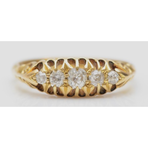 146 - An Edwardian 18ct gold and old cut brilliant diamond five stone ring, carved shoulders, N, 3.3gm