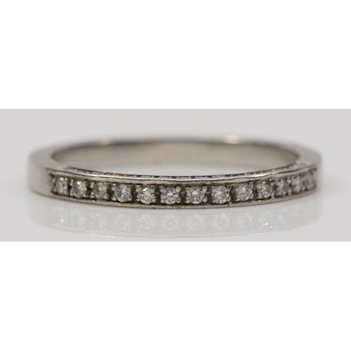 162 - A platinum brilliant cut diamond half eternity ring, with diamonds set to the side, Q, 4gm.