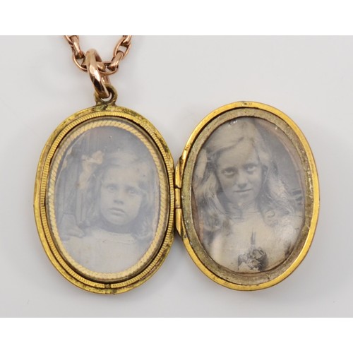 180 - A Victorian gold front and backed enamel oval locket, 31 x 22mm, unmarked, with a 9ct gold chain, ch... 