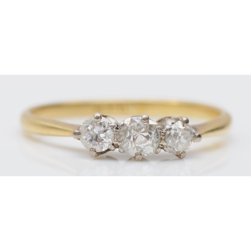 187 - An 18ct gold three stone diamond ring, claw set with two old cut brilliant and one brilliant cut sto... 