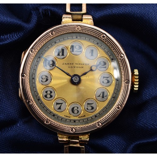 214 - A 9ct gold cased ladies wrist watch, by James Walker, London, the silvered dial set with Arabic nume... 