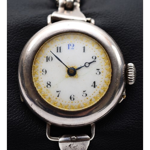 216 - An early 20th century silver ladies wrist watch, by Stockwell & Co, 1916, the enamel dial set with A... 