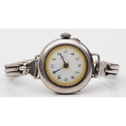 216 - An early 20th century silver ladies wrist watch, by Stockwell & Co, 1916, the enamel dial set with A... 