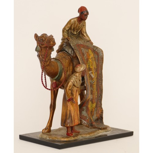 229 - A cold painted spelter table lighter of two Arab gentlemen selling carpets on the back of a camel, i... 