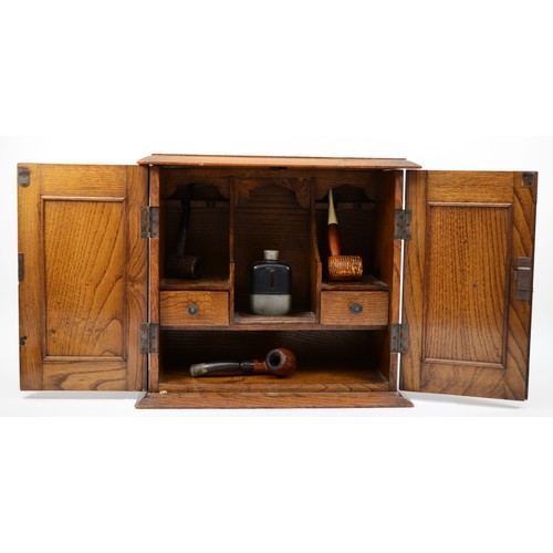 238 - An Arts and Crafts oak and hammered copper twin door smokers cabinet, the panels decorated with styl... 