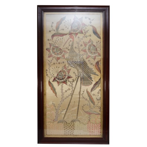 247 - A 20th century silk stump work style embroidery of a standing crane amongst flowers, 95x46cm, framed... 