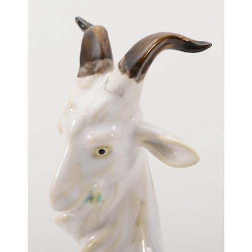 261 - A richly painted and glazed porcelain figural group of four goats raised on naturalistic base, unsig... 