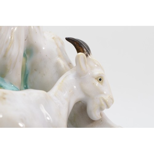 261 - A richly painted and glazed porcelain figural group of four goats raised on naturalistic base, unsig... 