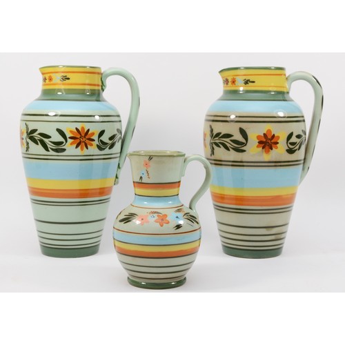 275 - Castleford Pottery; three 20th century painted and glazed jugs decorated in the Peasant pattern, 27c... 