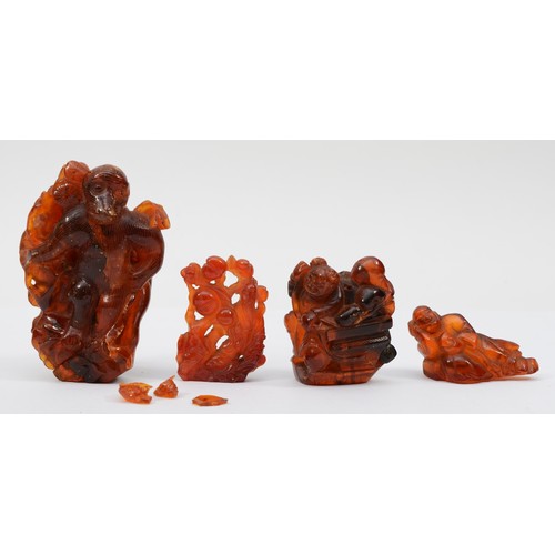 281 - Three Chinese 20th century carved amber figures comprising of two fisherman, 5.3cm high, a standing ... 