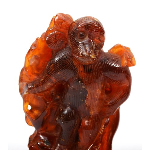 281 - Three Chinese 20th century carved amber figures comprising of two fisherman, 5.3cm high, a standing ... 