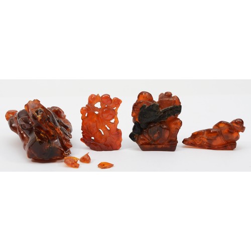 281 - Three Chinese 20th century carved amber figures comprising of two fisherman, 5.3cm high, a standing ... 