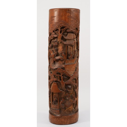 283 - A 20th century Chinese carved bitong (bushpot), with deeply relief carved village scene, 38cm high.