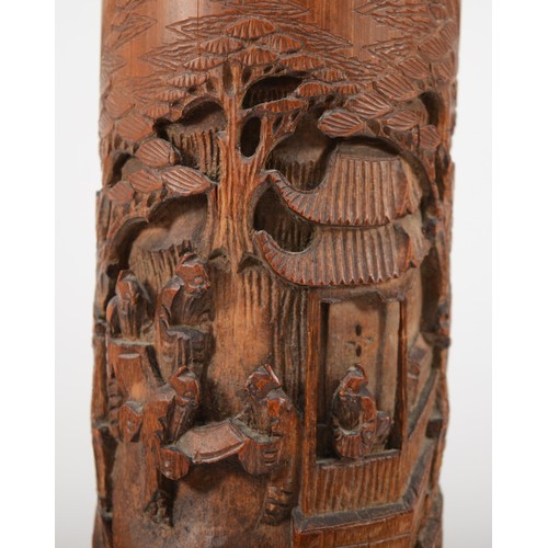 283 - A 20th century Chinese carved bitong (bushpot), with deeply relief carved village scene, 38cm high.