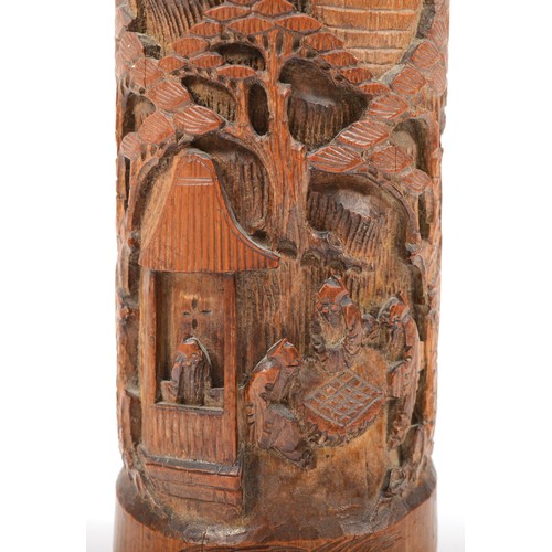 283 - A 20th century Chinese carved bitong (bushpot), with deeply relief carved village scene, 38cm high.