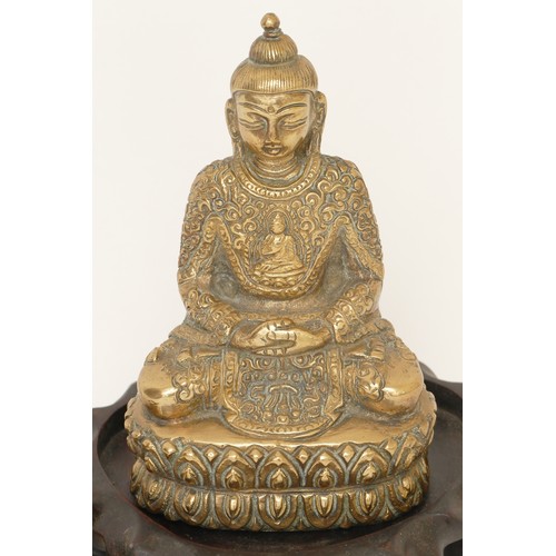 284 - A Chinese cast brass seated Dhyana Buddha cross legged seated on a lotus plant, 14cm high together w... 