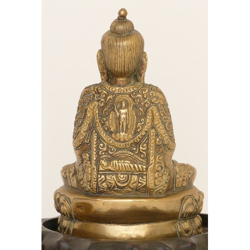 284 - A Chinese cast brass seated Dhyana Buddha cross legged seated on a lotus plant, 14cm high together w... 