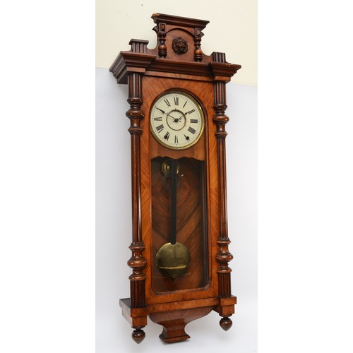 317 - A walnut veneered Vienna style wall clock, late 19th century, the cornice mounted with the head of a... 